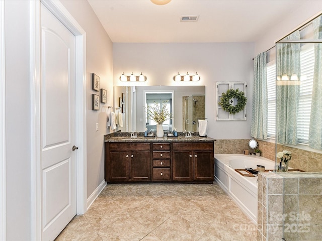 2005 Arbor Hills Dr, Indian Trail, NC 28079 - bathroom featuring a bath, plenty of natural light, double vanity, and an enclosed shower