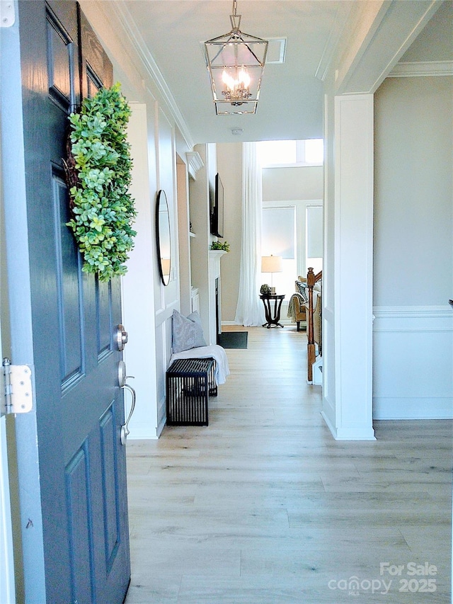 1141 Overlake Dr, Belmont, NC 28012 - entryway featuring ornamental molding, light wood finished floors, and a chandelier