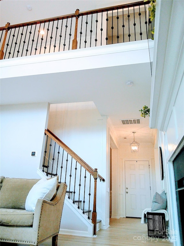 1141 Overlake Dr, Belmont, NC 28012 - stairs with a chandelier and wood finished floors