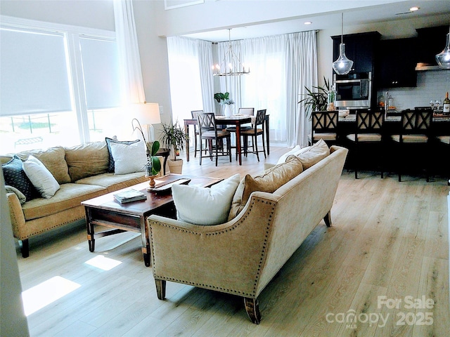 1141 Overlake Dr, Belmont, NC 28012 - living room featuring a chandelier and wood finished floors