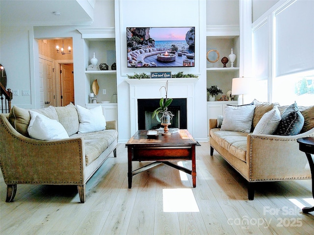 1141 Overlake Dr, Belmont, NC 28012 - living room featuring light wood finished floors, built in shelves, and a fireplace