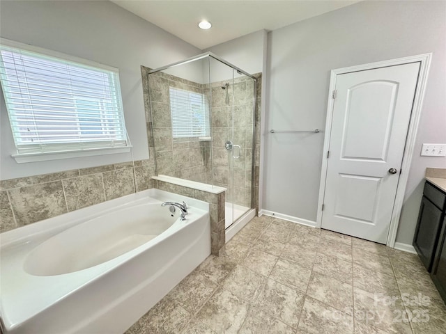 11109 Pond Valley Ct, Charlotte, NC 28269 - full bathroom with a bath, a shower stall, vanity, and recessed lighting