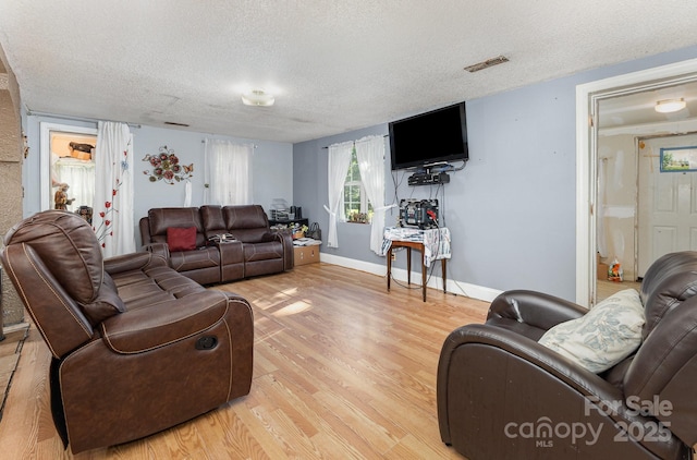 8301 Pine Oak Rd, Waxhaw, NC 28173 - living area featuring a textured ceiling and light wood finished floors