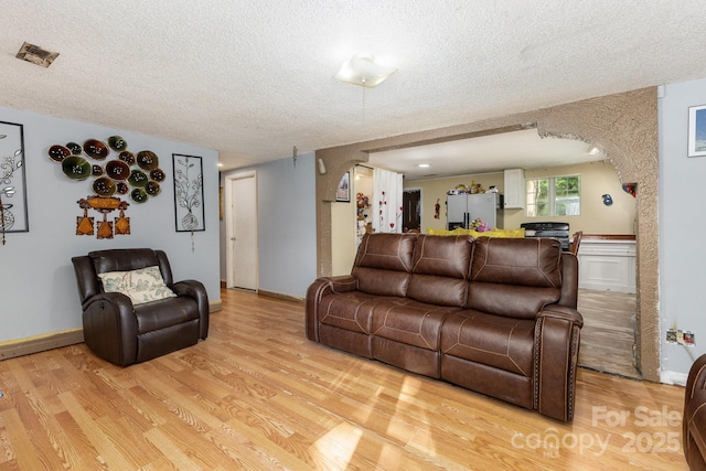 8301 Pine Oak Rd, Waxhaw, NC 28173 - living area with a textured ceiling and light wood-style floors