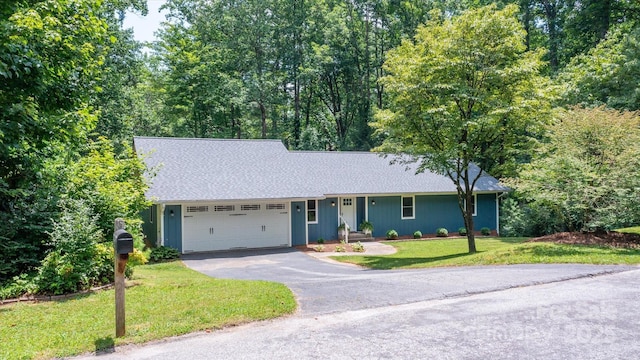 104 Britton Ave, Hendersonville, NC 28791 - ranch-style home featuring asphalt driveway, a garage, a front lawn, and roof with shingles