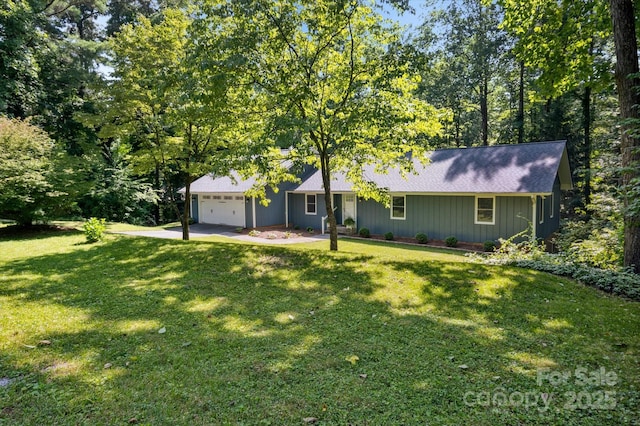 104 Britton Ave, Hendersonville, NC 28791 - view of front of property featuring a garage, a front yard, a shingled roof, and driveway