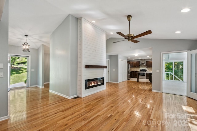 104 Britton Ave, Hendersonville, NC 28791 - unfurnished living room featuring vaulted ceiling, light wood-type flooring, a ceiling fan, a fireplace, and recessed lighting