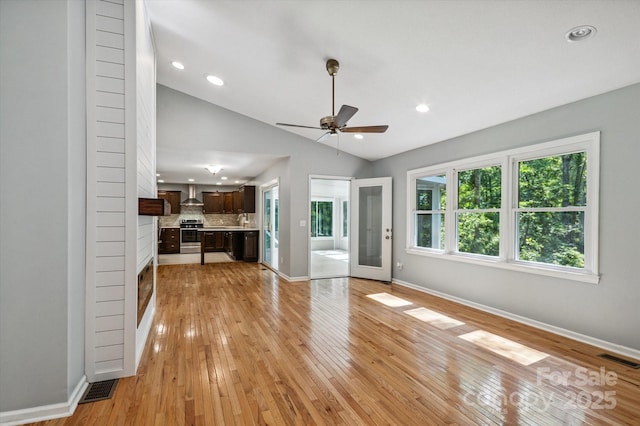 104 Britton Ave, Hendersonville, NC 28791 - unfurnished living room featuring a ceiling fan, lofted ceiling, light wood-style floors, and recessed lighting
