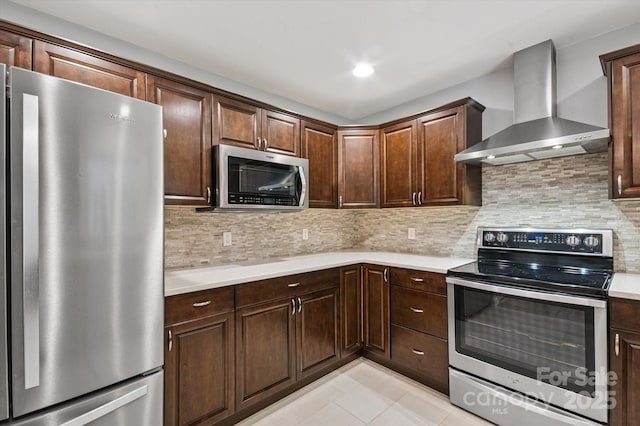 104 Britton Ave, Hendersonville, NC 28791 - kitchen with appliances with stainless steel finishes, wall chimney range hood, light countertops, light tile patterned floors, and backsplash