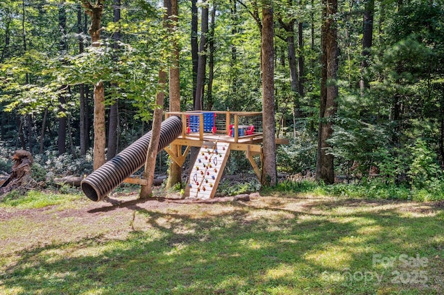 104 Britton Ave, Hendersonville, NC 28791 - view of play area featuring a deck, a yard, and a wooded view