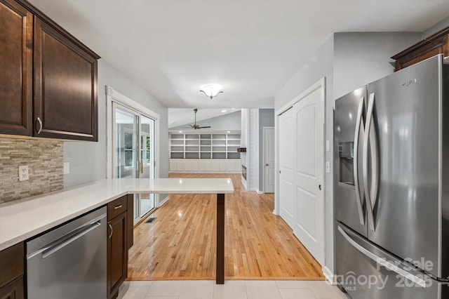 104 Britton Ave, Hendersonville, NC 28791 - kitchen featuring stainless steel appliances, dark brown cabinets, light countertops, backsplash, and ceiling fan