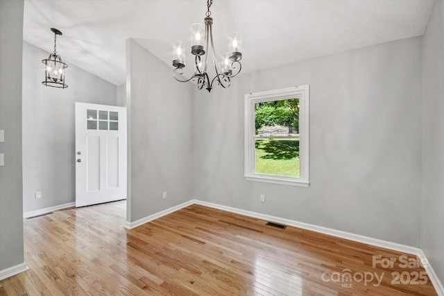 104 Britton Ave, Hendersonville, NC 28791 - unfurnished dining area featuring a chandelier, light wood-style flooring, and vaulted ceiling