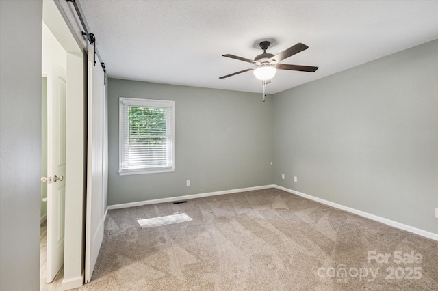 104 Britton Ave, Hendersonville, NC 28791 - unfurnished room with carpet, ceiling fan, and a barn door