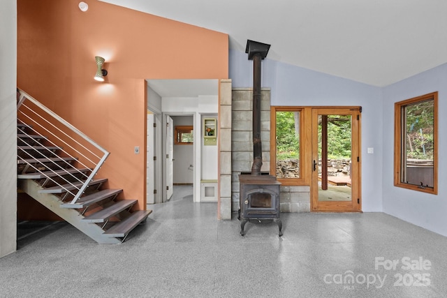 27 Rosebud Ln, Fairview, NC 28730 - entrance foyer with a wood stove, speckled floor, lofted ceiling, and stairway