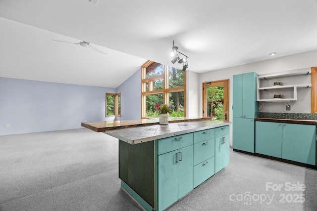 27 Rosebud Ln, Fairview, NC 28730 - kitchen featuring open shelves, lofted ceiling, a center island, and a ceiling fan