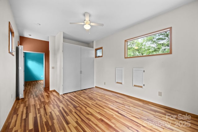 27 Rosebud Ln, Fairview, NC 28730 - unfurnished bedroom featuring light wood-type flooring, a closet, and a ceiling fan