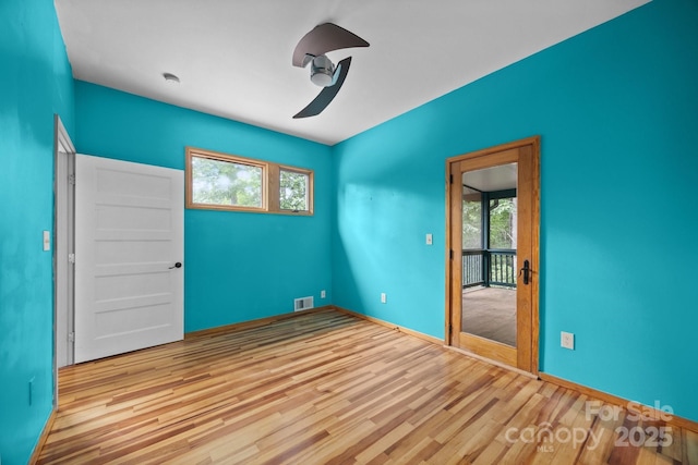 27 Rosebud Ln, Fairview, NC 28730 - empty room featuring healthy amount of natural light, wood finished floors, and ceiling fan