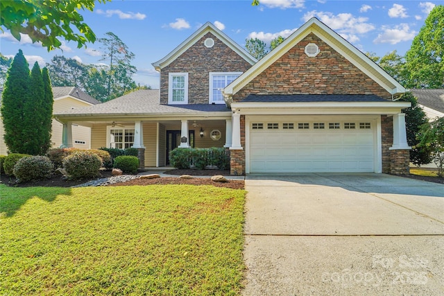1237 Saint Johns Ave, Matthews, NC 28104 - craftsman house featuring concrete driveway, a front yard, a garage, covered porch, and stone siding