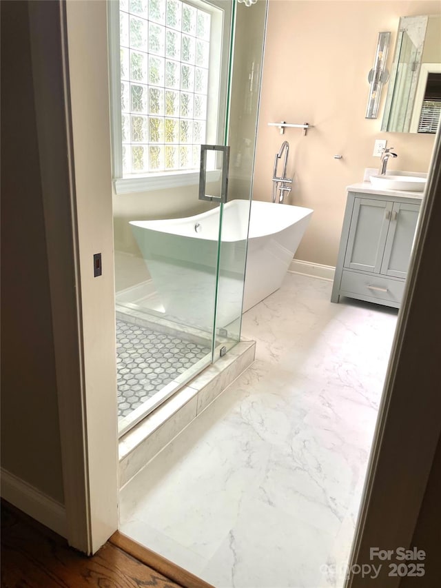 1237 Saint Johns Ave, Matthews, NC 28104 - bathroom featuring marble finish flooring, vanity, a freestanding bath, and a stall shower
