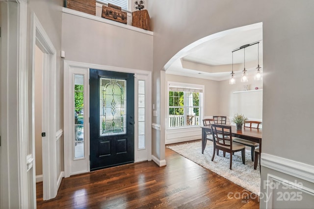 1237 Saint Johns Ave, Matthews, NC 28104 - foyer entrance with arched walkways, dark wood-style flooring, and a raised ceiling