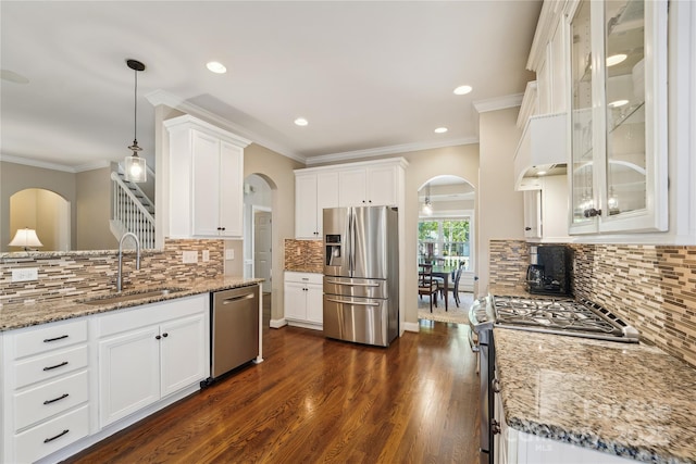 1237 Saint Johns Ave, Matthews, NC 28104 - kitchen featuring stainless steel appliances, arched walkways, tasteful backsplash, white cabinets, and light stone counters