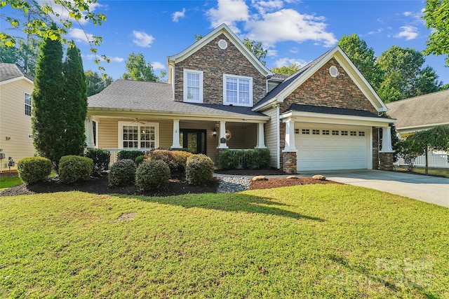 1237 Saint Johns Ave, Matthews, NC 28104 - view of front facade with driveway, a front lawn, a garage, and covered porch