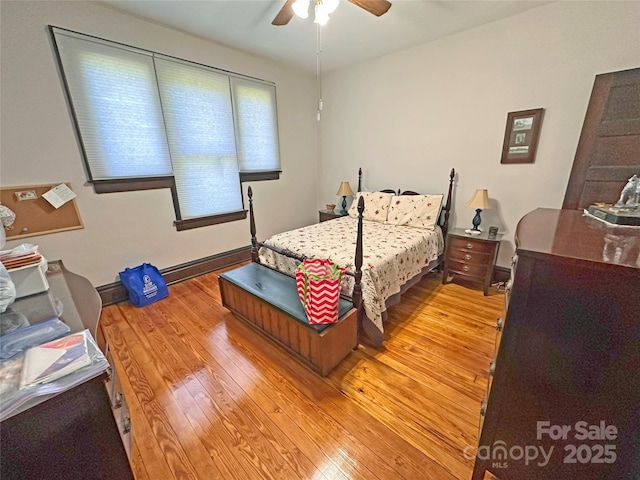 318 N Laurel St N, Lincolnton, NC 28092 - bedroom with light wood-style flooring, ceiling fan, and a baseboard heating unit