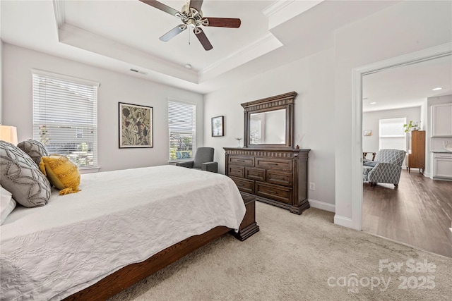 1009 Kemp Rd, Indian Trail, NC 28079 - bedroom with crown molding, a raised ceiling, light colored carpet, and a ceiling fan