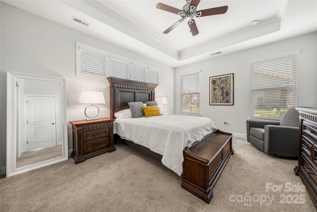 1009 Kemp Rd, Indian Trail, NC 28079 - bedroom featuring a tray ceiling, light colored carpet, ornamental molding, and a ceiling fan