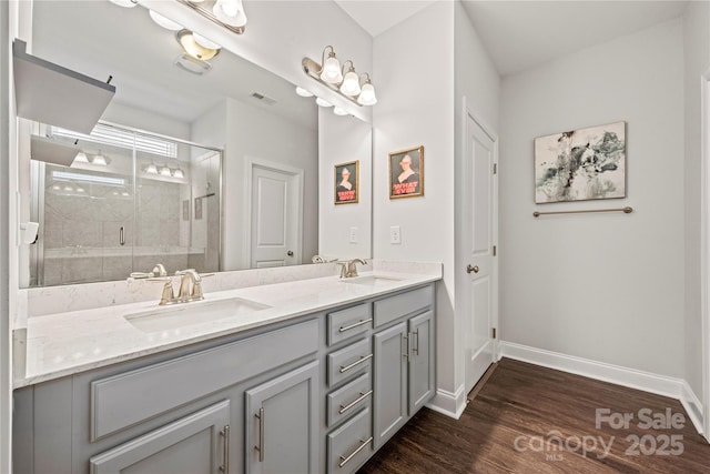 1009 Kemp Rd, Indian Trail, NC 28079 - full bathroom with double vanity, wood finished floors, and a shower stall