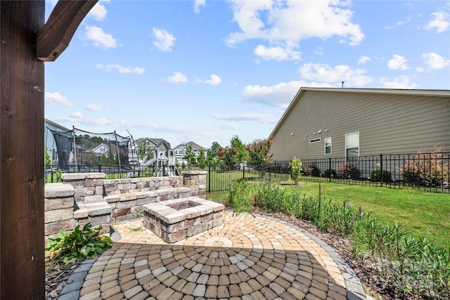 1009 Kemp Rd, Indian Trail, NC 28079 - view of patio / terrace with a trampoline, an outdoor fire pit, and a residential view