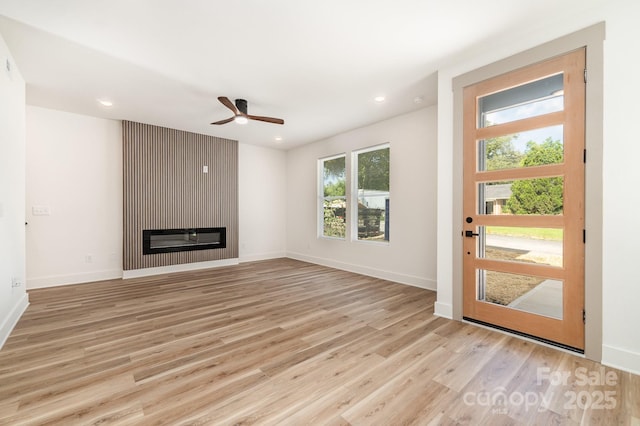 101 Bryan St, Kannapolis, NC 28083 - unfurnished living room featuring light wood-style floors, a ceiling fan, a fireplace, and recessed lighting