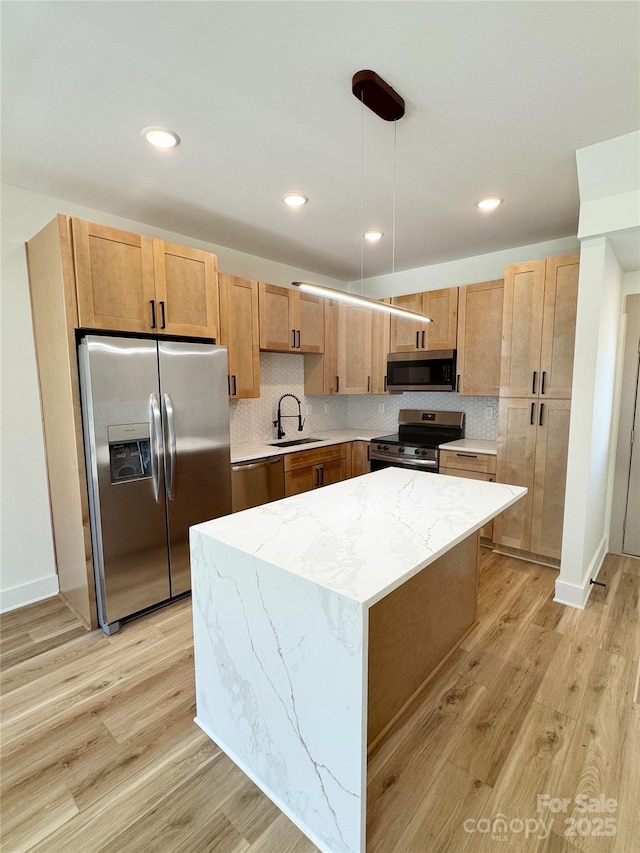 101 Bryan St, Kannapolis, NC 28083 - kitchen with appliances with stainless steel finishes, light wood-type flooring, tasteful backsplash, a center island, and recessed lighting
