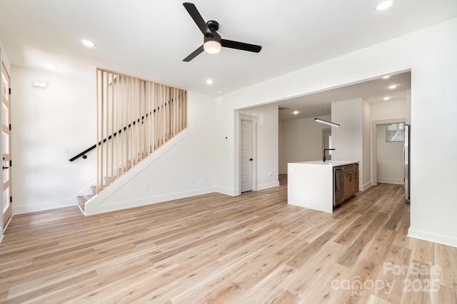 177 Georgia St SW, Concord, NC 28025 - unfurnished living room featuring a ceiling fan, stairs, light wood-type flooring, and recessed lighting