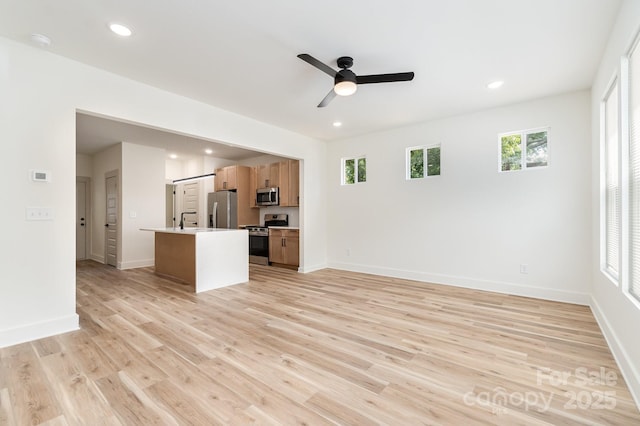 177 Georgia St SW, Concord, NC 28025 - unfurnished living room with a ceiling fan, light wood finished floors, and recessed lighting