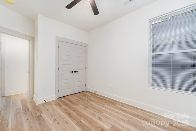 177 Georgia St SW, Concord, NC 28025 - unfurnished bedroom featuring light wood-type flooring, a closet, and ceiling fan