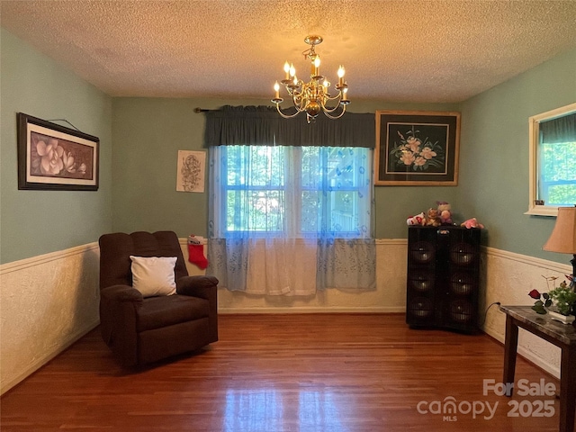 6708 Nutcracker Pl, Charlotte, NC 28212 - sitting room with a wainscoted wall, a textured ceiling, wood finished floors, and a chandelier