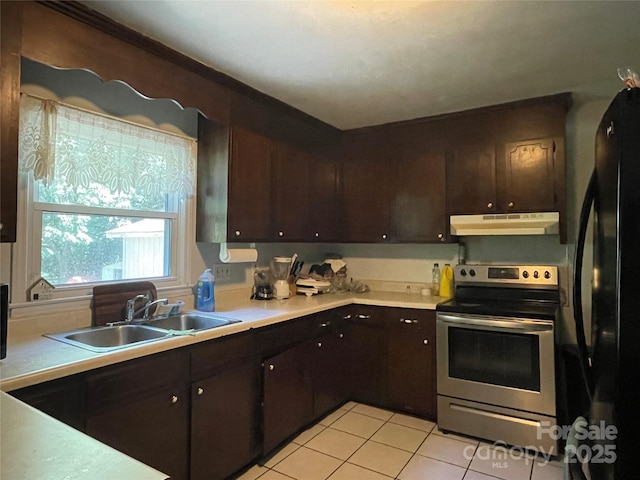 6708 Nutcracker Pl, Charlotte, NC 28212 - kitchen featuring electric stove, black refrigerator, under cabinet range hood, light tile patterned floors, and dark brown cabinetry