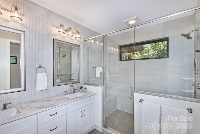 120 Gashes Creek Rd, Asheville, NC 28805 - bathroom featuring a shower stall, double vanity, tile walls, and tasteful backsplash