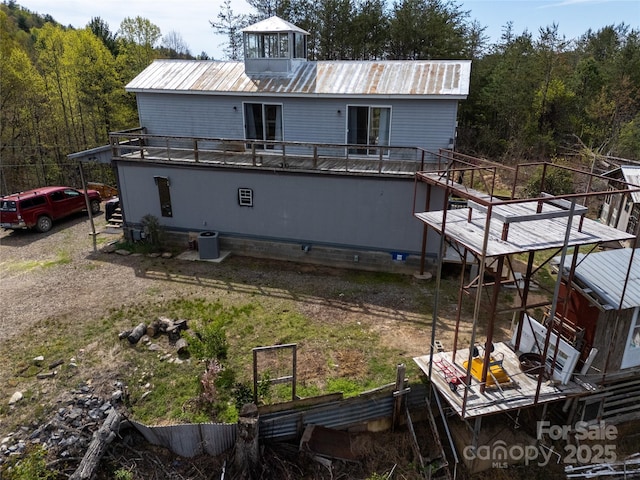 2668 Reedy Branch Rd, Purlear, NC 28665 - rear view of house with a metal roof, a forest view, and stairs