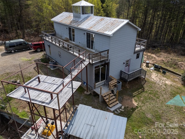 2668 Reedy Branch Rd, Purlear, NC 28665 - back of property with stairway, a view of trees, and a balcony