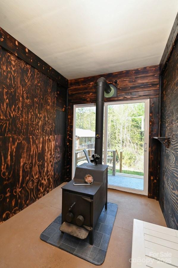 2668 Reedy Branch Rd, Purlear, NC 28665 - living room featuring wood walls and a wood stove