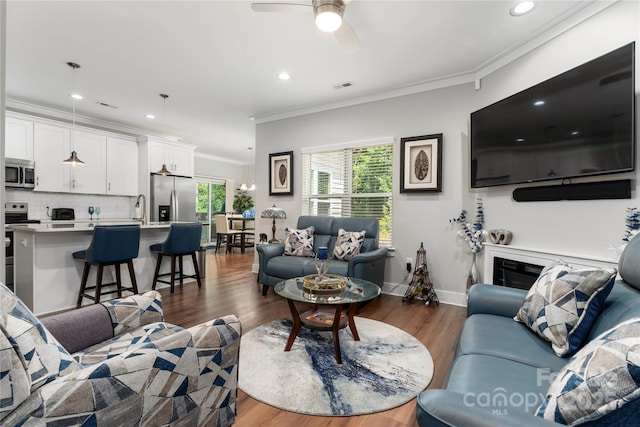 7516 Ohara St, Huntersville, NC 28078 - living area featuring wood finished floors, ornamental molding, a ceiling fan, and recessed lighting