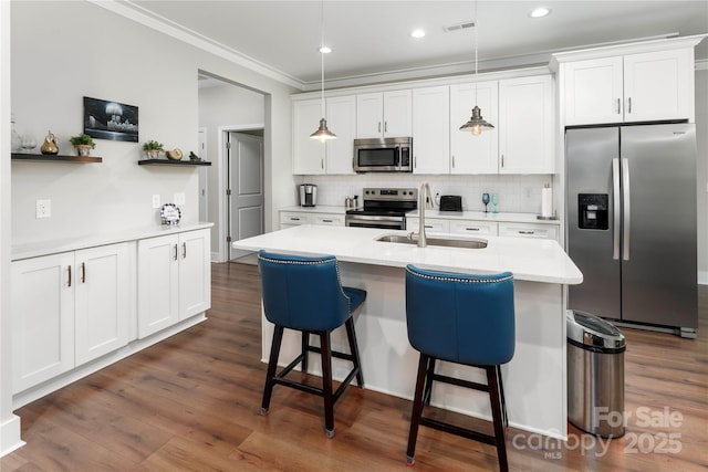 7516 Ohara St, Huntersville, NC 28078 - kitchen featuring appliances with stainless steel finishes, crown molding, dark wood-style flooring, a breakfast bar area, and backsplash