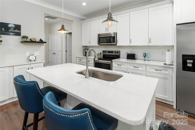7516 Ohara St, Huntersville, NC 28078 - kitchen with appliances with stainless steel finishes, a kitchen breakfast bar, dark wood-style floors, decorative backsplash, and recessed lighting