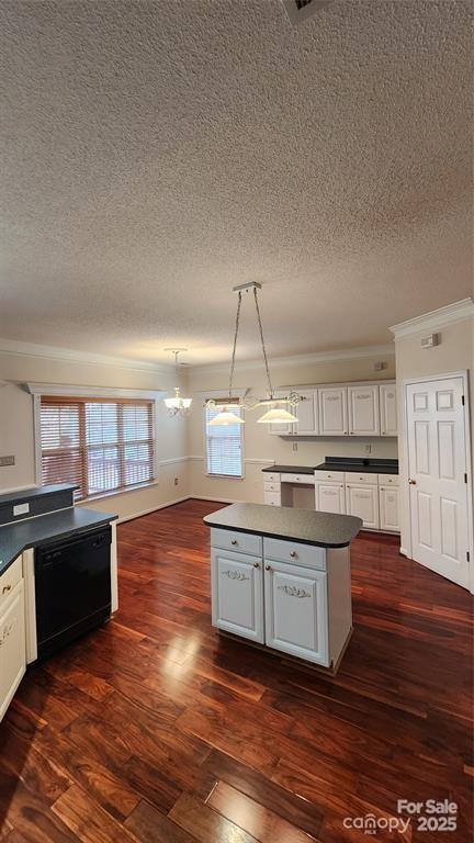 10607 Old Bridge Ln, Charlotte, NC 28269 - kitchen with dishwasher, dark countertops, crown molding, a textured ceiling, and a chandelier