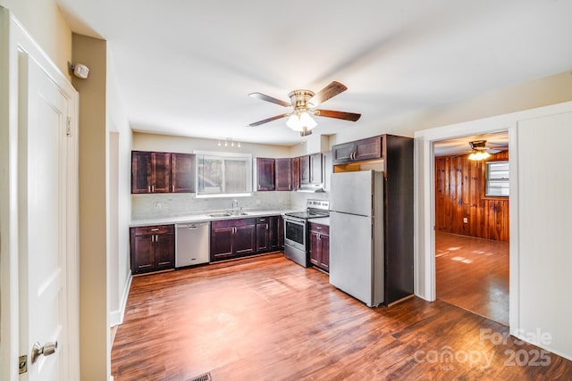 2405 Greenland Ave, Charlotte, NC 28208 - kitchen with stainless steel appliances, a ceiling fan, wood finished floors, light countertops, and backsplash