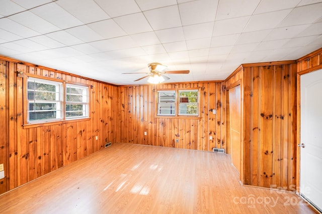 2405 Greenland Ave, Charlotte, NC 28208 - empty room with light wood finished floors, a ceiling fan, and wood walls