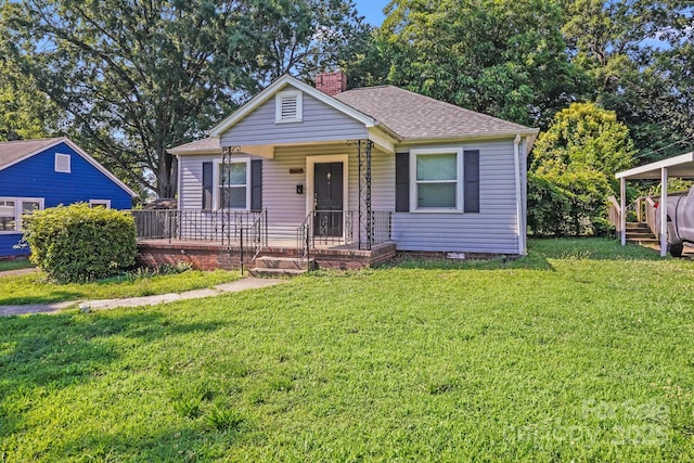 2405 Greenland Ave, Charlotte, NC 28208 - view of front of property with a chimney, a front yard, roof with shingles, and covered porch