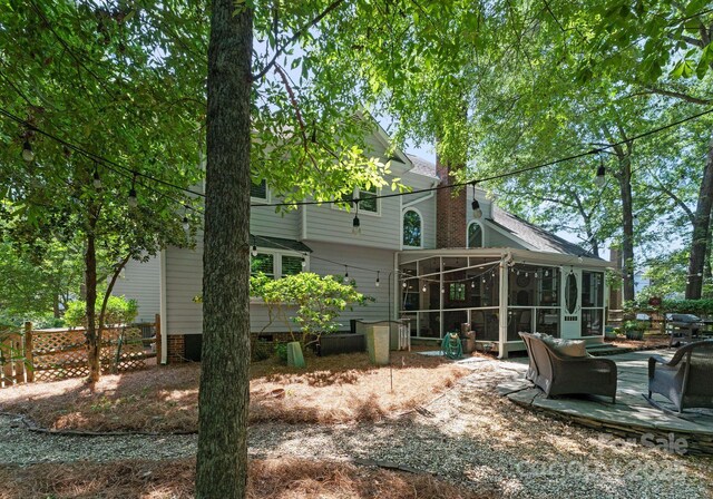 9141 Covey Hollow Ct, Charlotte, NC 28210 - rear view of property featuring a sunroom